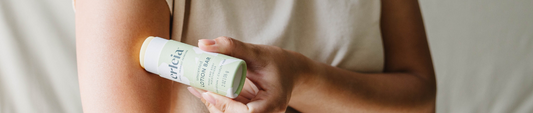 A person applying Erleia Unscented Lotion Bar to their arm