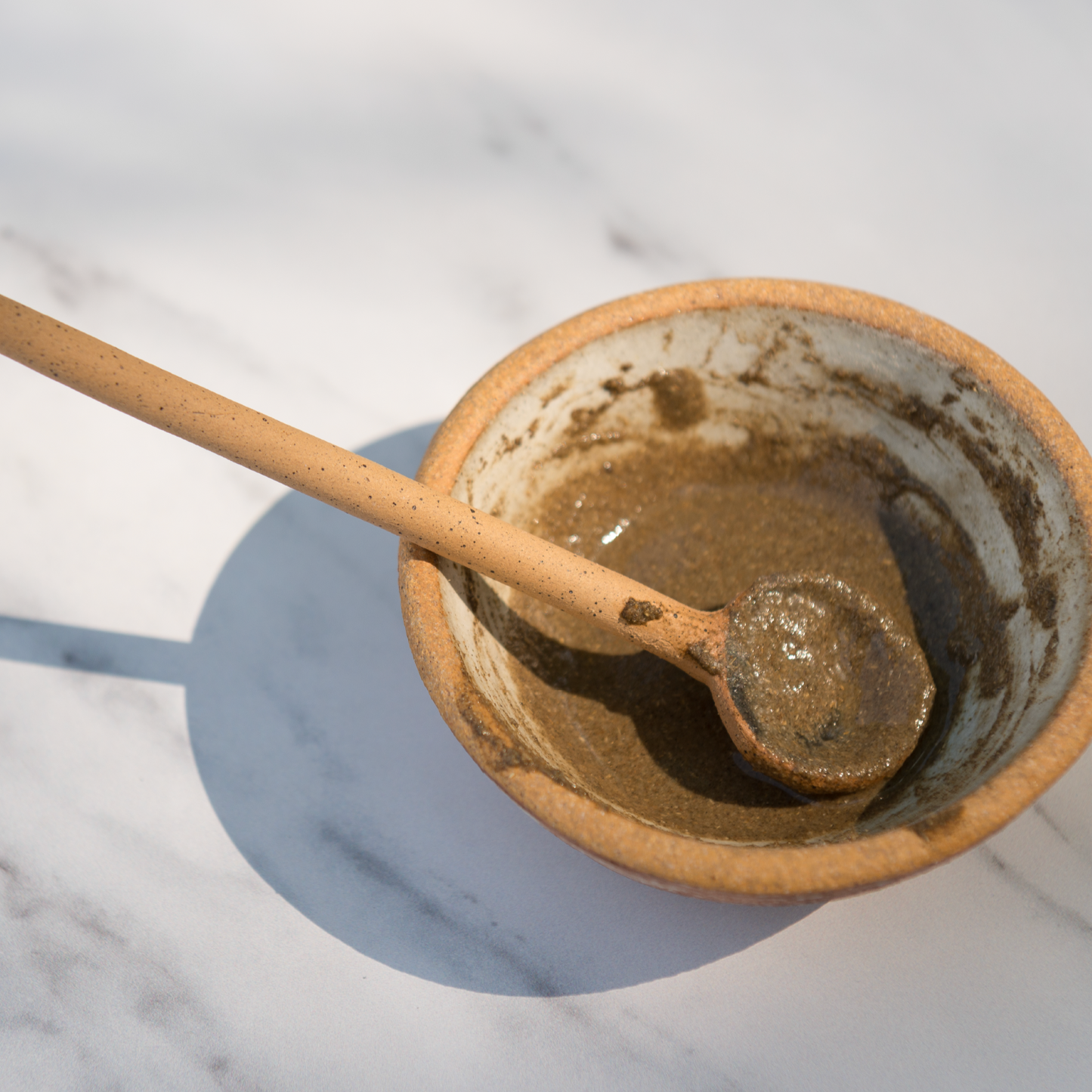 Erleia Humble Powder Cleanser mixed with water in a ceramic bowl