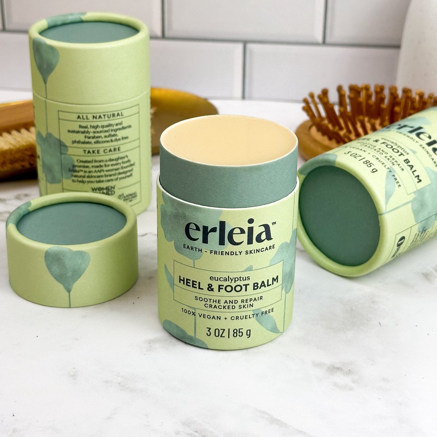 An uncapped, open Erleia eucalyptus Heel & Foot Balm on a bathroom counter