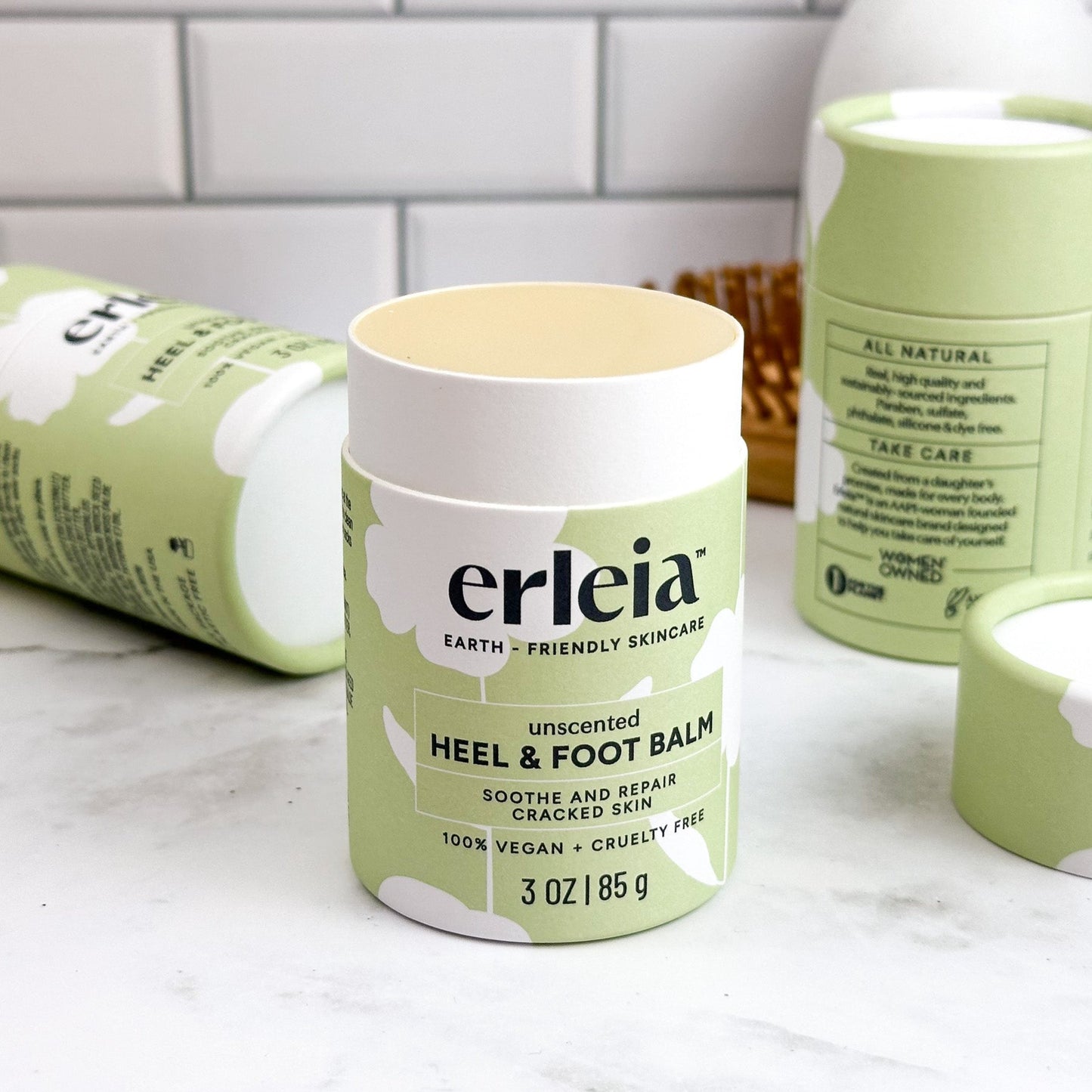An uncapped, open unscented Erleia heel & foot balm on a bathroom counter