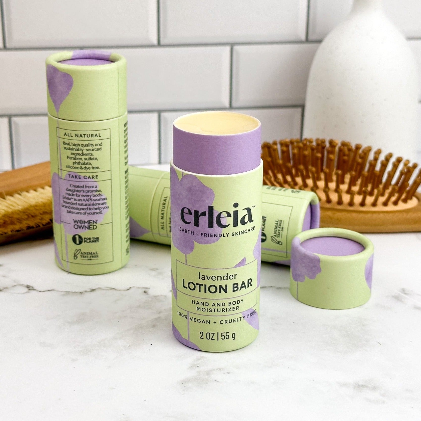 An Erleia lavender lotion bar, uncapped and open on a bathroom counter.