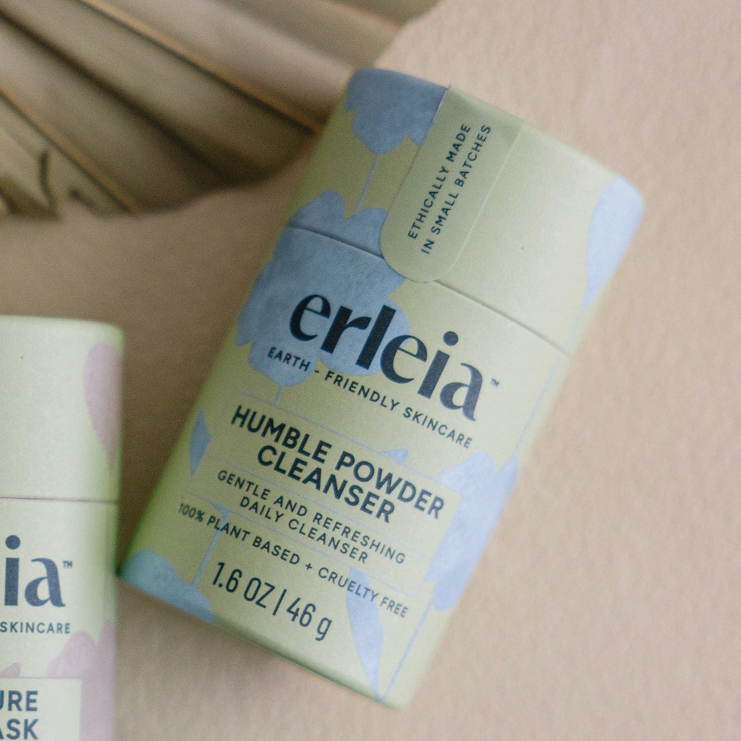 An Erleia Humble Powder Cleanser on a beige background