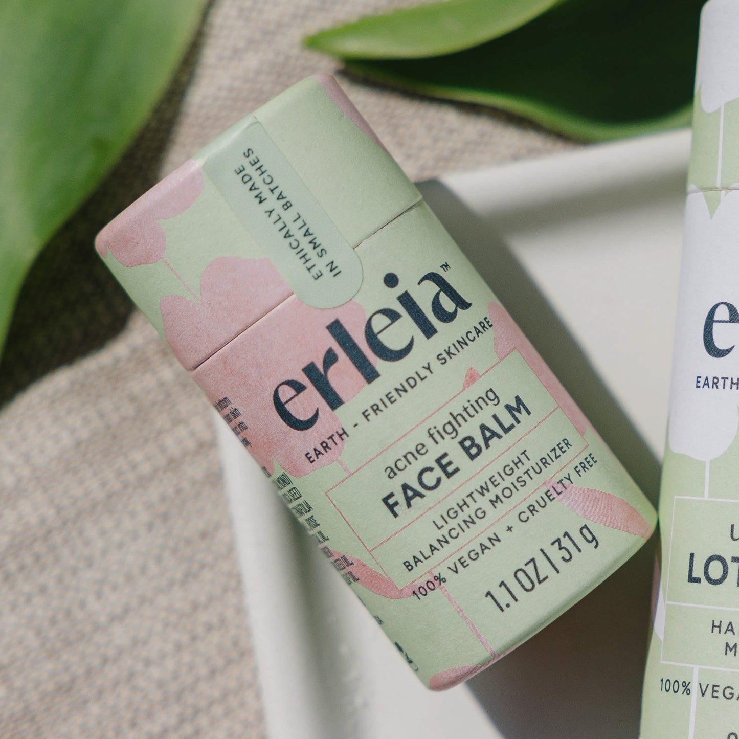 An Erleia acne fighting Face Balm on a white dish