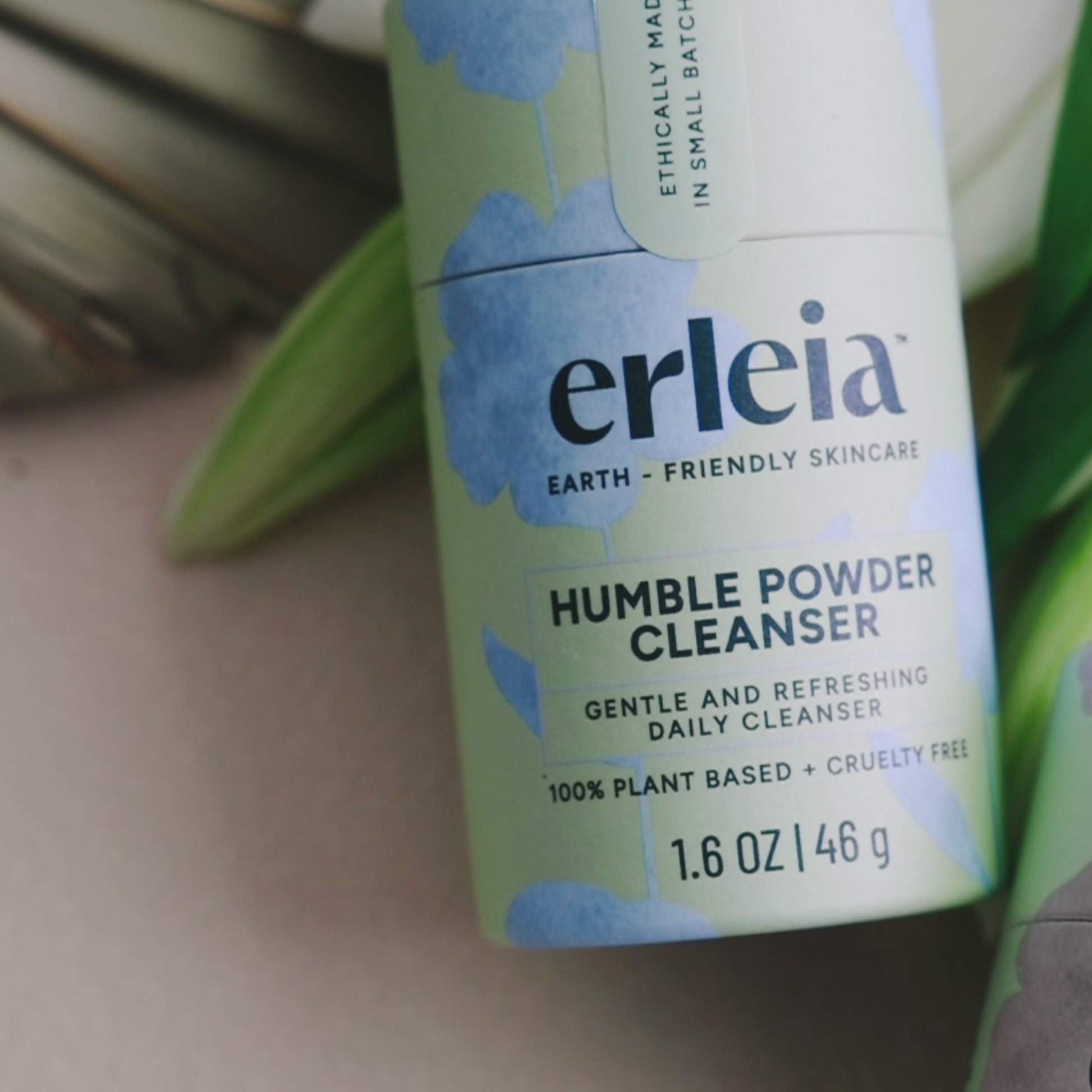 Erleia Humble Powder Cleanser is displayed, then an East Asian woman is shown smiling and applying the cleanser to her cheek.