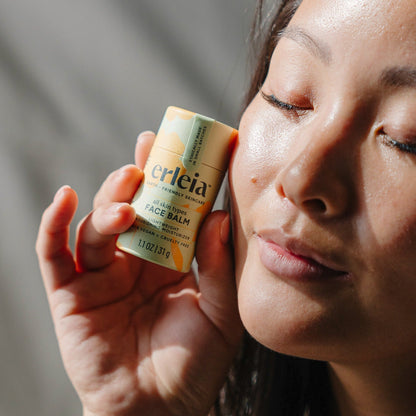 An East Asian woman holding an Erleia all skin types Face Balm