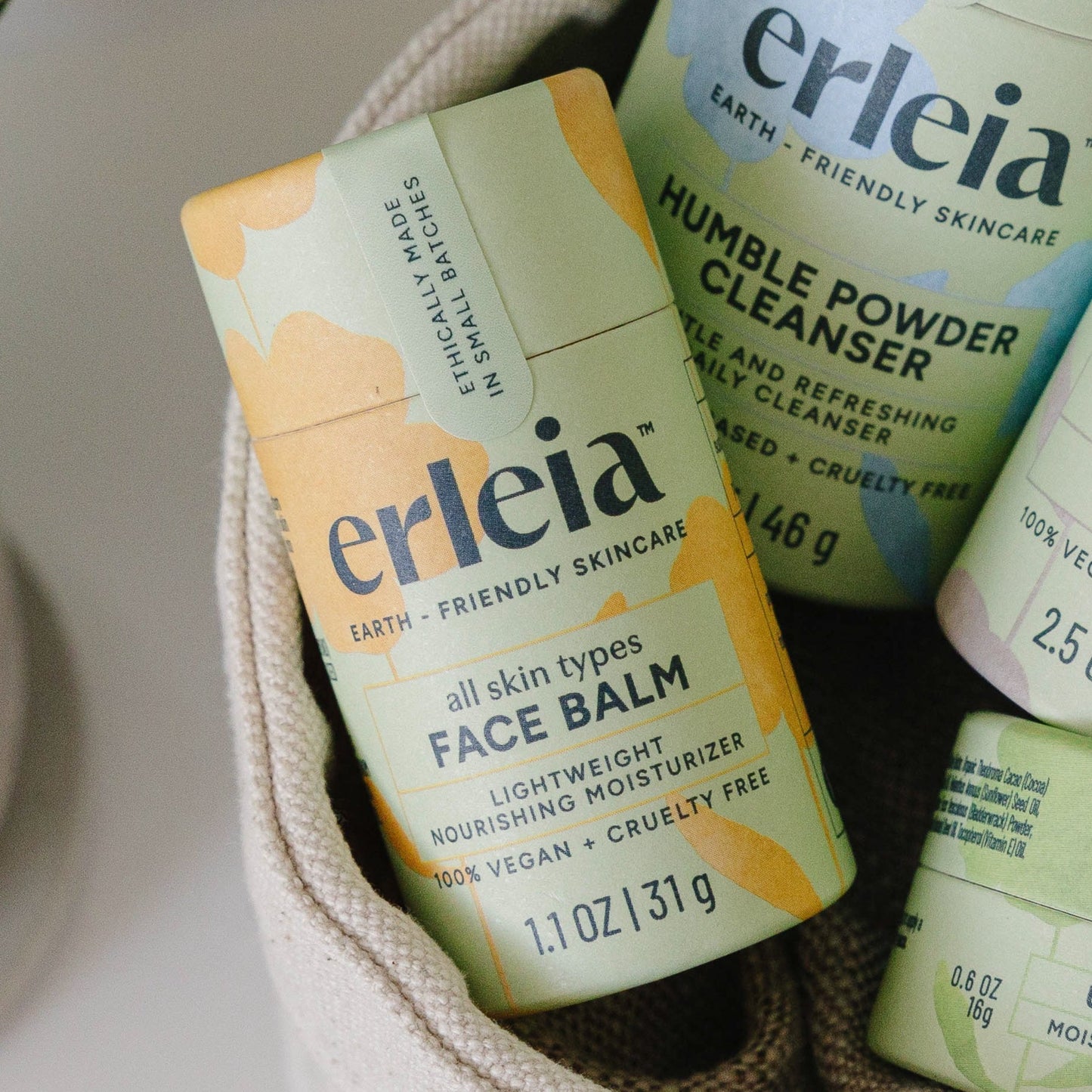 An Erleia all skin types Face Balm with other Erleia products in a fabric basket