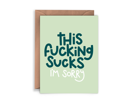 Greeting card that says "This fucking sucks I'm sorry" on a green background