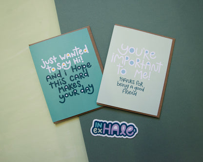 Two greeting cards and a sticker - one greeting card says "just wanted to say hi! And I hope this card makes your day" the other says "You're important to me, thanks for being a good friend". The sticker says "inhale and exhale".